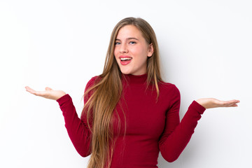 Teenager blonde girl over isolated white background with shocked facial expression