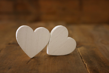 Valentines day concept. white hearts over wooden background. Flat lay composition
