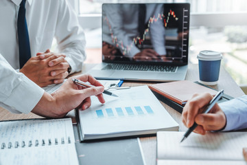 Business Team meeting Investment and Entrepreneur Trading Stock Market and Exchange discussing and analysis graph. © Nichapa