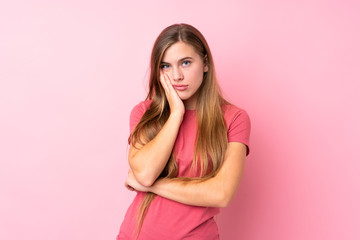 Teenager blonde girl over isolated pink background unhappy and frustrated