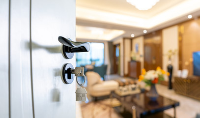 Open door with keys, key in keyhole