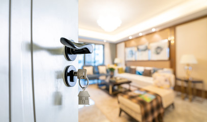 Open door with keys, key in keyhole