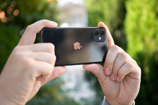 Man hand holding iPhone 11 takes pictures photo camera phone
