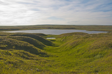 Fototapeta na wymiar Hills and lake in the tundra