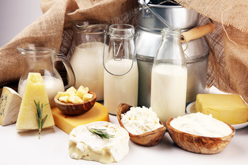 Different  healthy dairy products on rustic background with milk, cheese, butter and cottage