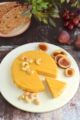 Homemade vegan cheese made from cashew nuts served with gluten free bread 