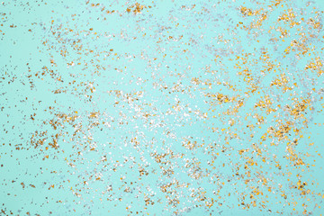 Golden sparkles on blue pastel trendy background. Festive backdrop for your projects.