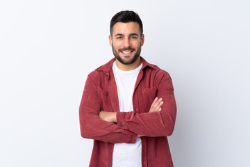 Young handsome man with beard wearing a corduroy jacket over isolated white background keeping the...