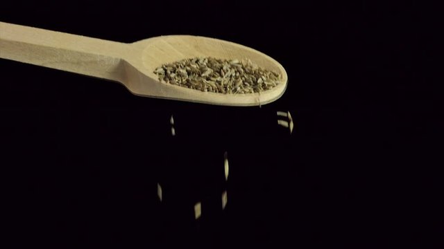 One spoon of cumin . Spices and food ingredients.