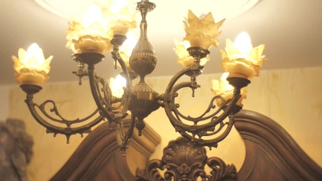 Footage of old fashion vintage chandelier. Camera turns around, low angle