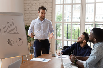 Young businessman interact with multiethnic workers at meeting
