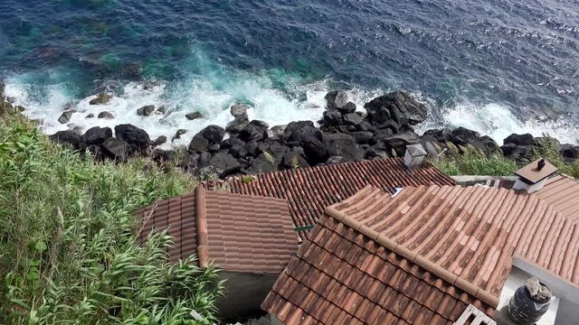 Red tiled roofs of residential and farm building at the Ponta do Arnel  promontory. Azores, Portugal.    