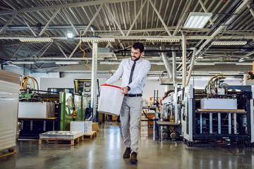 Full length of handsome caucasian bearded graphic engineer carrying bucket with liquid glue....