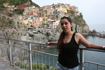 brunette caucasian curvy girl on a lookout point on the Cinque Terre coast in summer