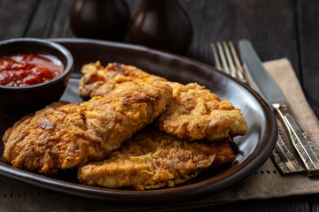 Turkey schnitzel, served with rice and pomegranate seeds.
