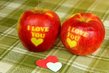 Two Red Apple with text I LOVE YOU on green backaground. I love you apple. Apple for Valentine's Day