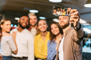 Happy colleagues making selfie. Casual business team taking collective photo