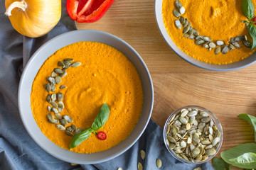 Roasted pumpkin and carrot soup with cream and seeds