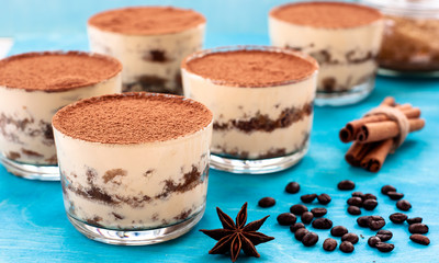 Glass filled with creamy tiramisu and lady fingers