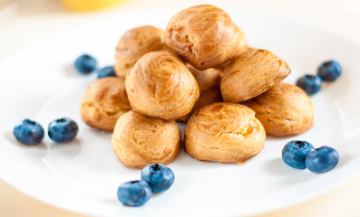 profiteroles with Blueberries on a white plate
