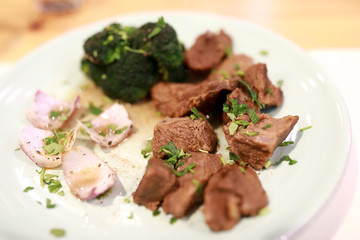 Fried veal with onions on plate