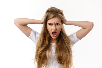 Fototapeta premium Portrait of young angry woman screaming on white background