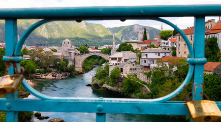 View of the panorama of Mostar through the fence of a Port Bridge (Lucki Most) over the Neretva river. Mostar, Bosnia and Herzegovina.