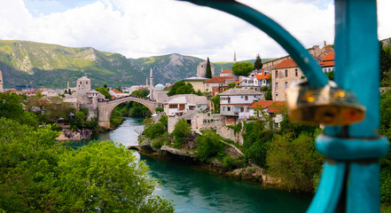 View of Old Bridge and the city of Mostar through the fence of a Harbor Bridge ( Mujage Komadine...