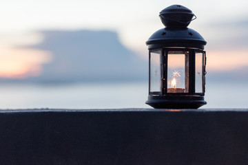 Earth hour 2020 concept. Lantern or Eid lamp with candle inside at night. Ramadan Kareem background.