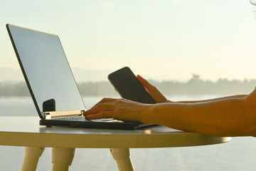 Freelance man using multichannel online network 5G technology internet tablet and laptop working in...