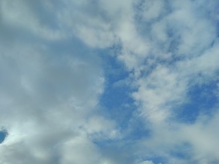 White fluffy clouds in the blue sky. Beautiful nature and outdoor view with white cloud on blue sky background