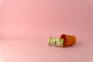 100 USD roll inside small bucket  isolate on pink color background space use as online shopping business concept