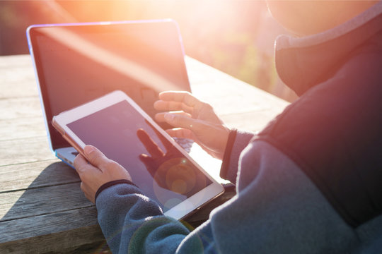 Causal professional Business man using multichannel services with internet wifi 5G on smartphone and online tablet in coffee shop.City lifestyle businessman hands working using mobile phone concept