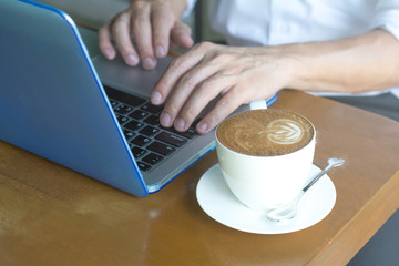 Official professional Business man using multichannel services with internet wifi 5G on smartphone and online tablet in coffee shop.City lifestyle businessman hands working using mobile phone concept