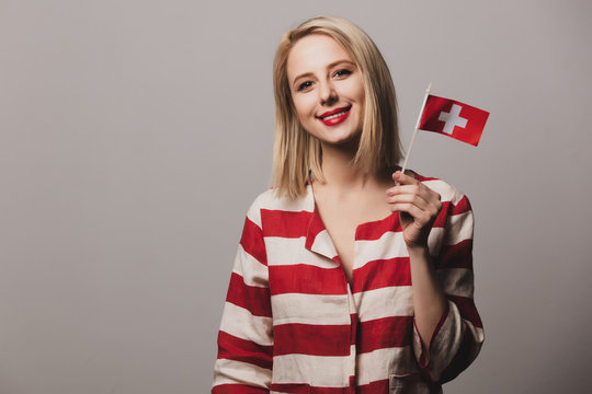 girl holds Switzerland flag on gray backgrou
