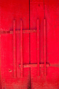 Red door of church with wood latch Thai traditional style, antique wooden door Buddhist temple gate with wooden door red color vintage style