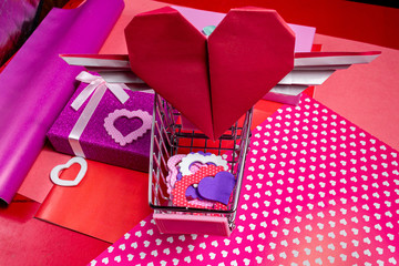 Present gift for Valentine day with heart card on the pink background