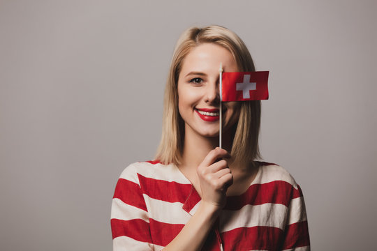 girl holds Switzerland flag on gray background