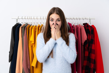 Young woman in a clothing store with surprise facial expression