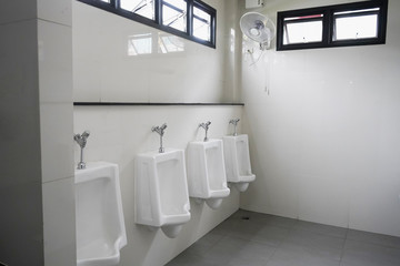 Public gentlemen toilet restroom .white ceramic urinals for men in the  gas stations