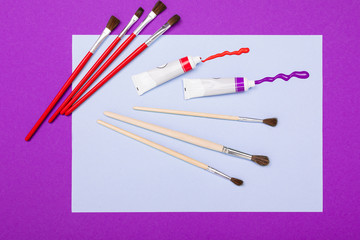 design concept. brushes for watercolors and watercolor paints lie on canvas on the table