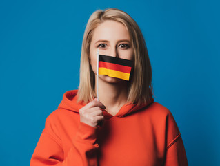 beatiful girl holds flag of Germany in hand