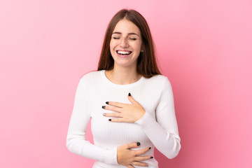 Fototapeta premium Young woman over isolated pink background smiling a lot