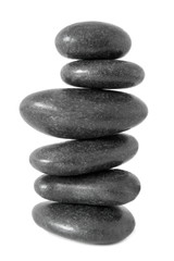 Stacked natural smooth grey stones in zen balance  isolated on white background