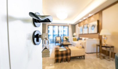 Open door with keys, key in keyhole