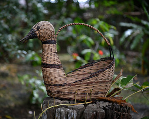 wicker basket in the form of a swan in a tropical garden