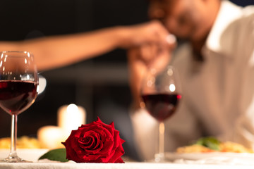 Red Rose Lying On Table, Man Kissing Woman's Hand Indoor