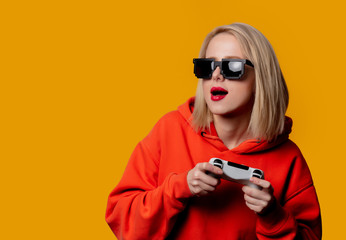 girl in sunglasses keen plays with a joystick