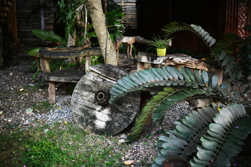 wooden chair made from antique wooden pieces in a tropical garden
