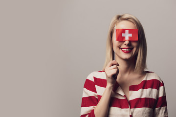 girl holds Switzerland flag on gray background